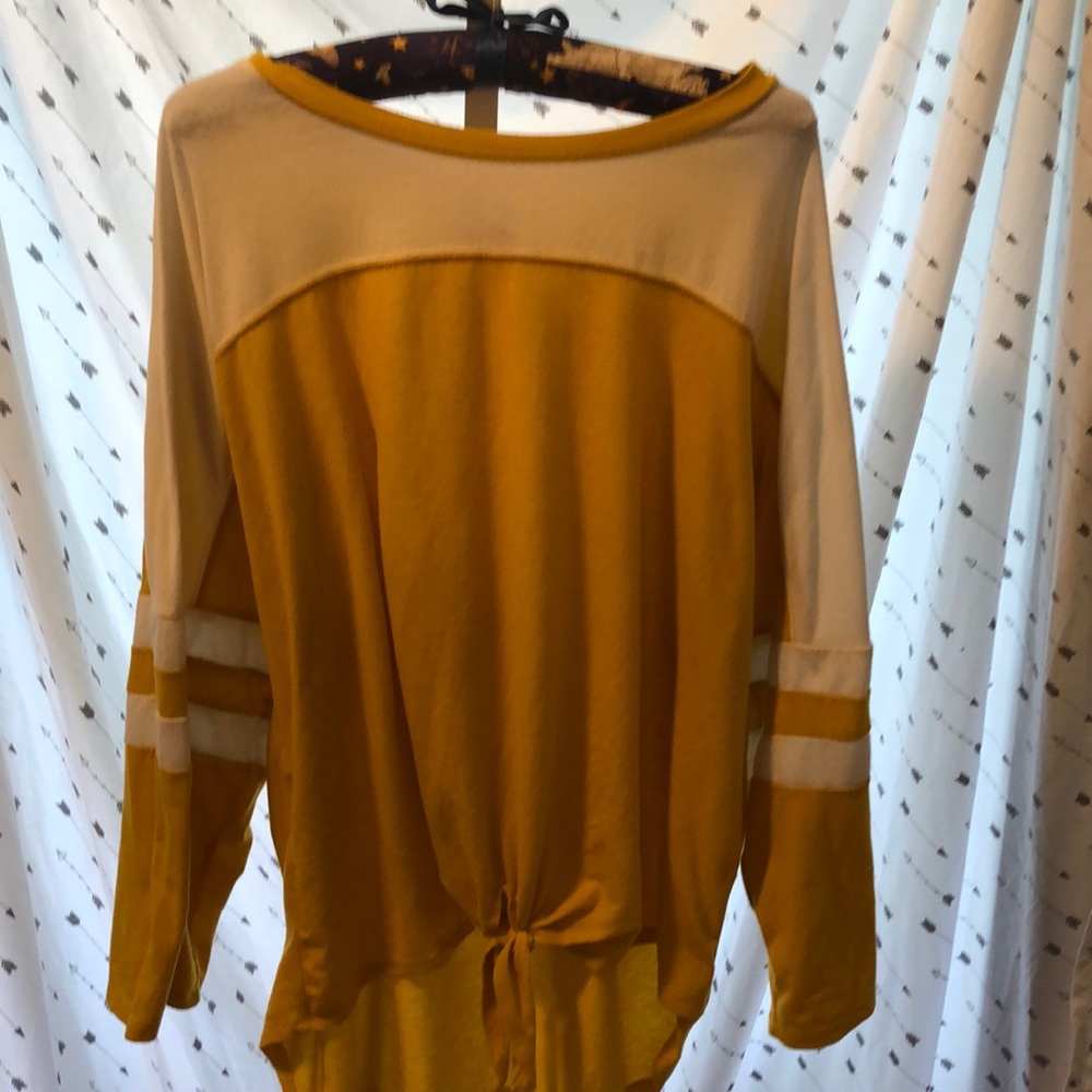 Mustard yellow 3-quarter shirt.
